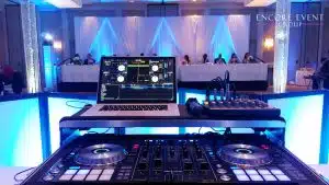 Example photo of wedding DJ setup with reception lighting Example photo of wedding DJ setup with reception lighting
