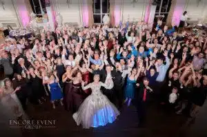 DJ entertaining on packed wedding dance floor DJ entertaining on packed wedding dance floor
