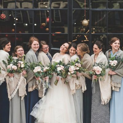 Happy couple with string lighting at their wedding reception Happy couple dancing under decorative lighting at wedding reception