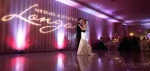 couple dancing with wedding gobo on wall scaled couple dancing with wedding gobo on wall scaled
