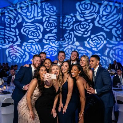 Wedding guests posing under breakup pattern gobo lighting