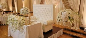 high_back_love_seat_with_ivory_drapes_lights-min