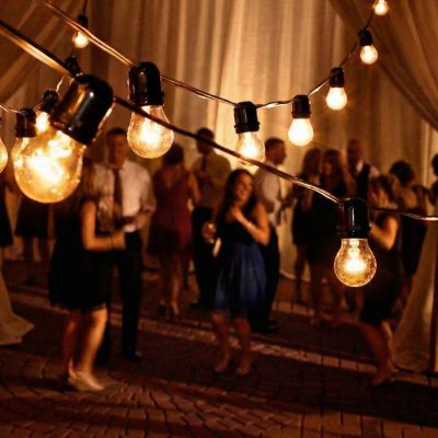 Edison-style bistro lights creating warm glow over Jeffersonville wedding dance floor Edison-style bistro lights creating warm glow over Jeffersonville wedding dance floor