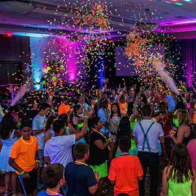 School dance floor glowing under UV lights with confetti School dance floor glowing under UV lights with confetti