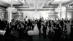 Guests gathered on dance floor celebrating with the couple Guests gathered on dance floor celebrating with the couple