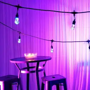Edison and LED string lighting creating soft ambiance at event space Edison and LED string lighting creating soft ambiance at event space
