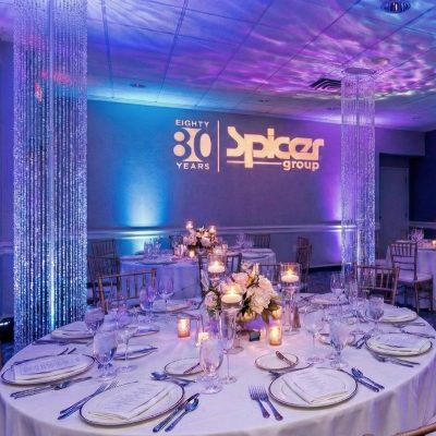 Tall crystal chandelier pillars placed between tables at a wedding reception