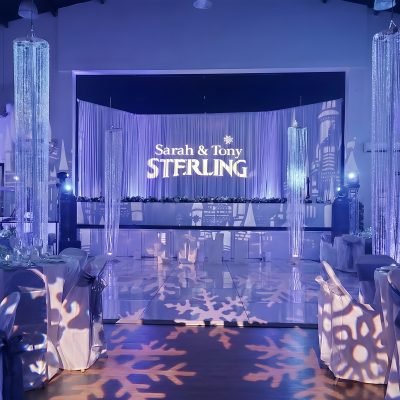 Winter wedding monogram lighting with draping and indoor effects