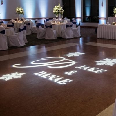 Custom wedding monogram gobo lighting on dance floor at reception