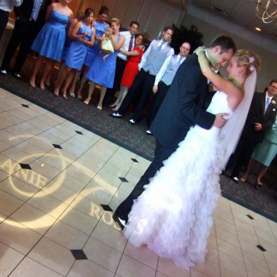 Wedding first dance inside custom monogram projection on dance floor