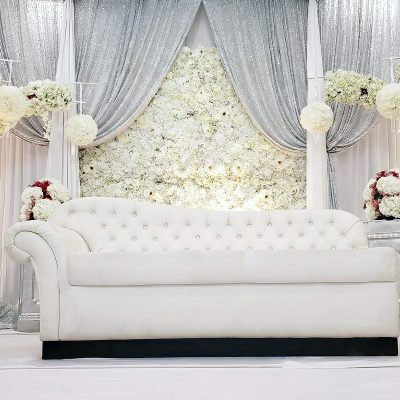 Floral backdrops with draping setup behind chaise as stage decor Floral backdrops with draping setup behind chaise as stage decor