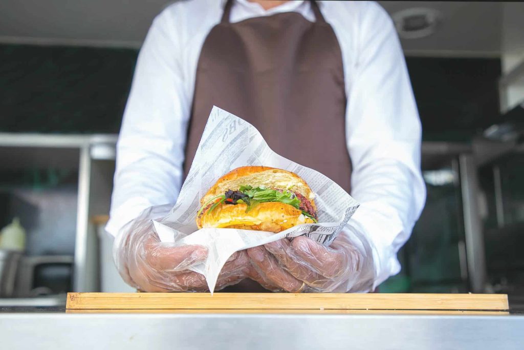 Wedding food truck handing over burger Wedding food truck handing over burger